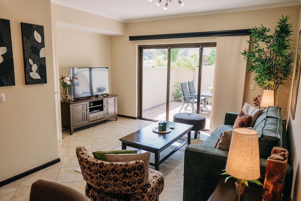 Overview of the living room, television and patio doors