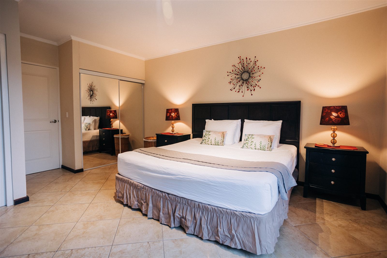 Wide view of the main bedroom and mirrored wardrobe