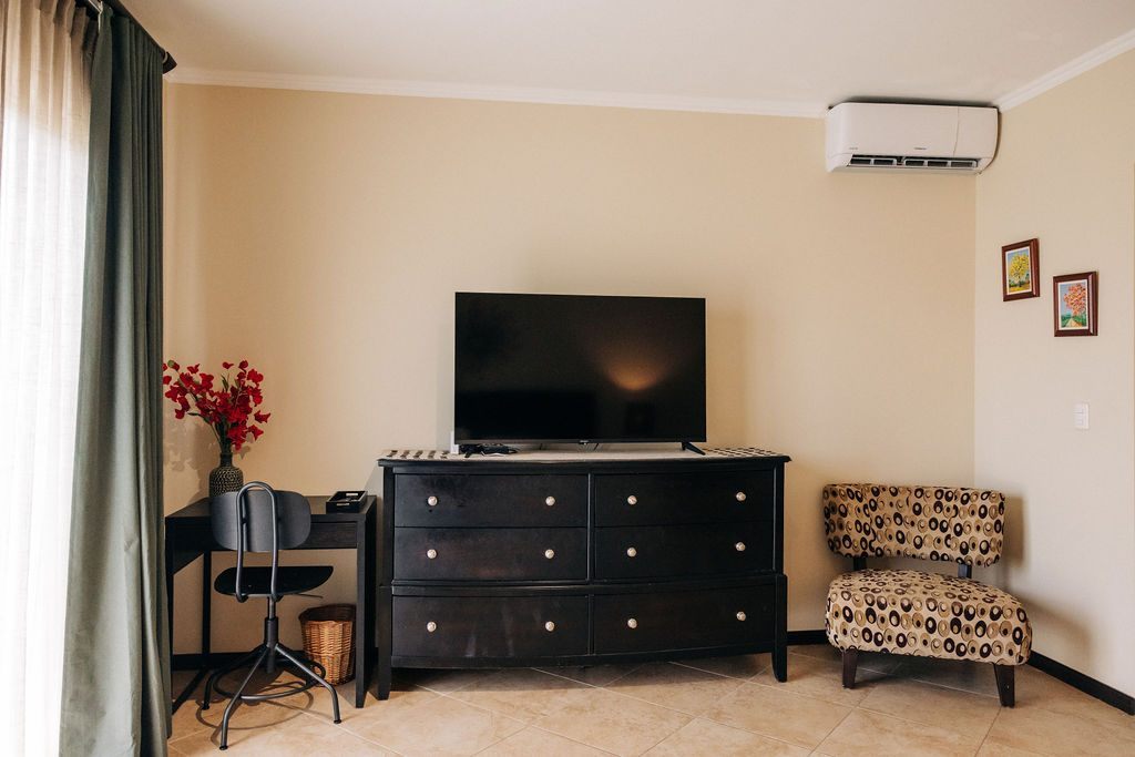 Television, dresser and desk in the main bedroom