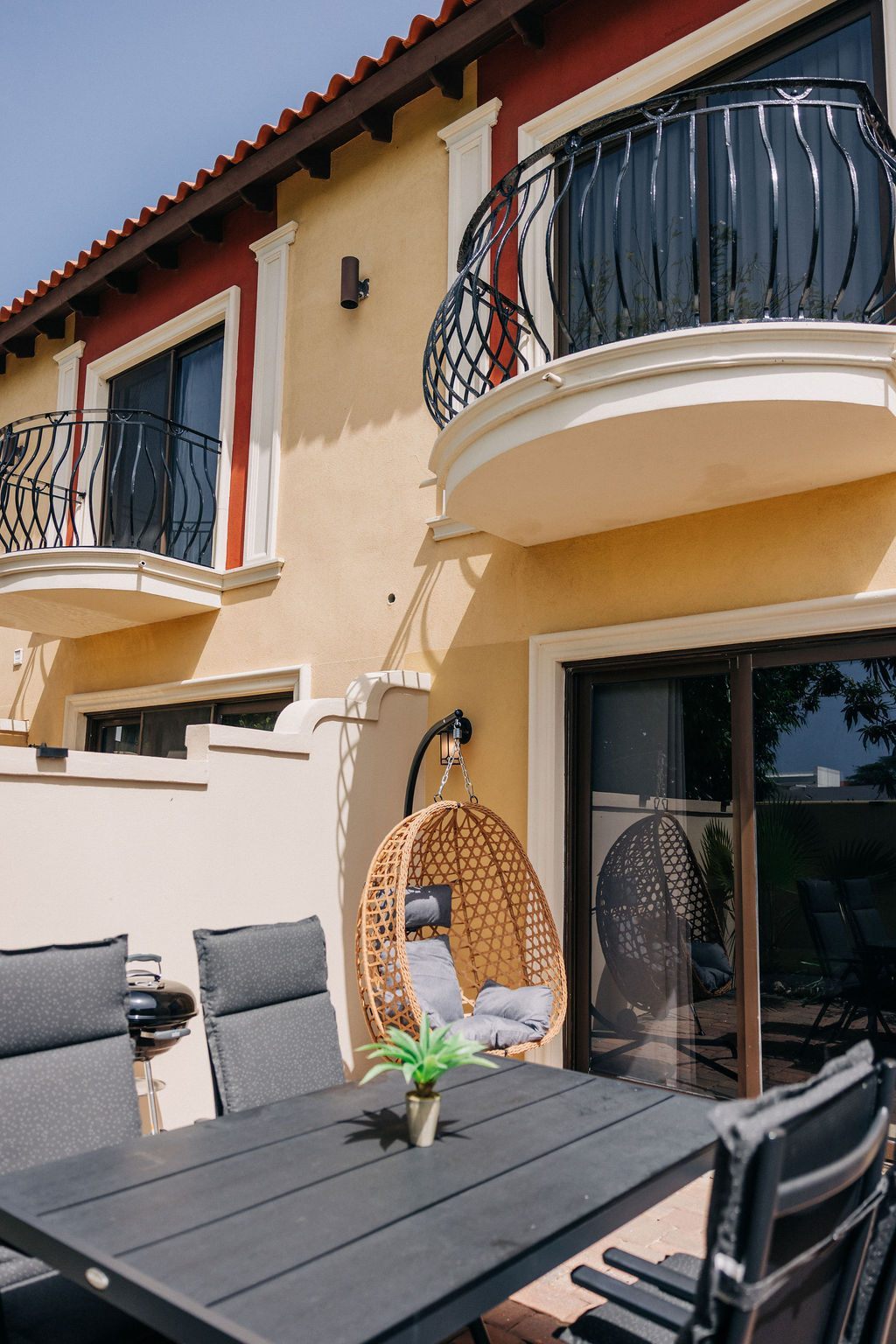 Patio beneath the balconies of the townhome